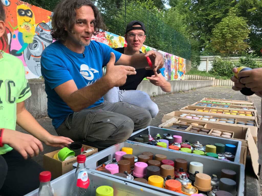 Michael Schoberth mit Teilnehmenden bei einem Graffiti-Workshop